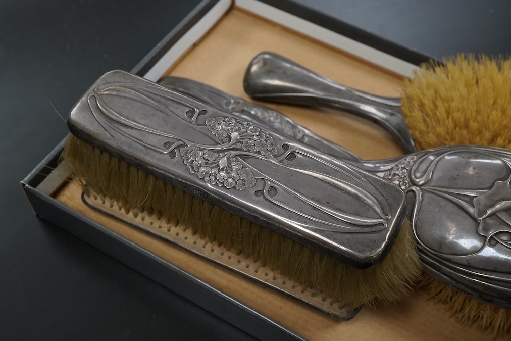 An Art Nouveau Hutton & Son silver mounted five piece dressing table set